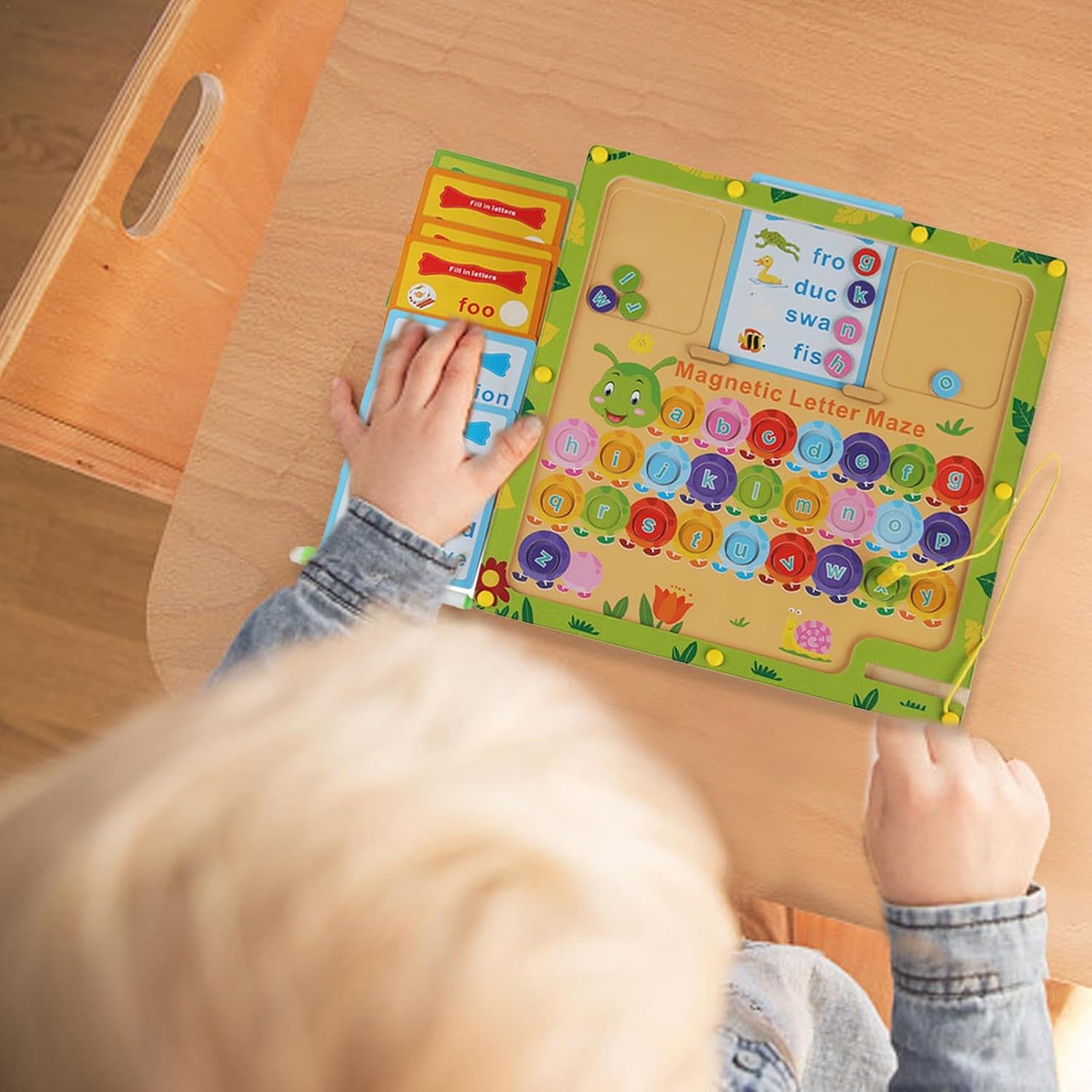Child playing with a colorful educational toy on a wooden table