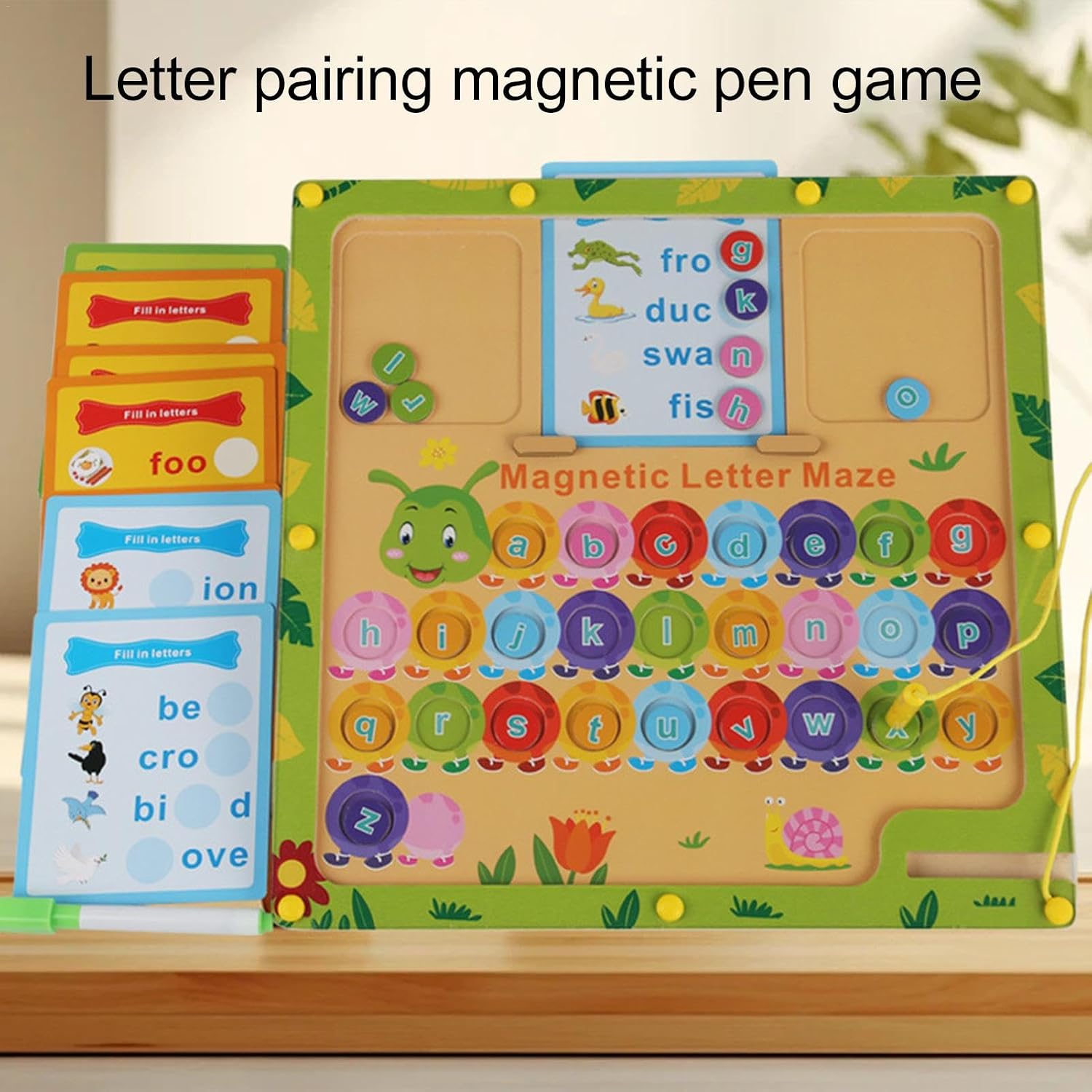 Letter pairing magnetic pen game with colorful letters and cards on a wooden surface.