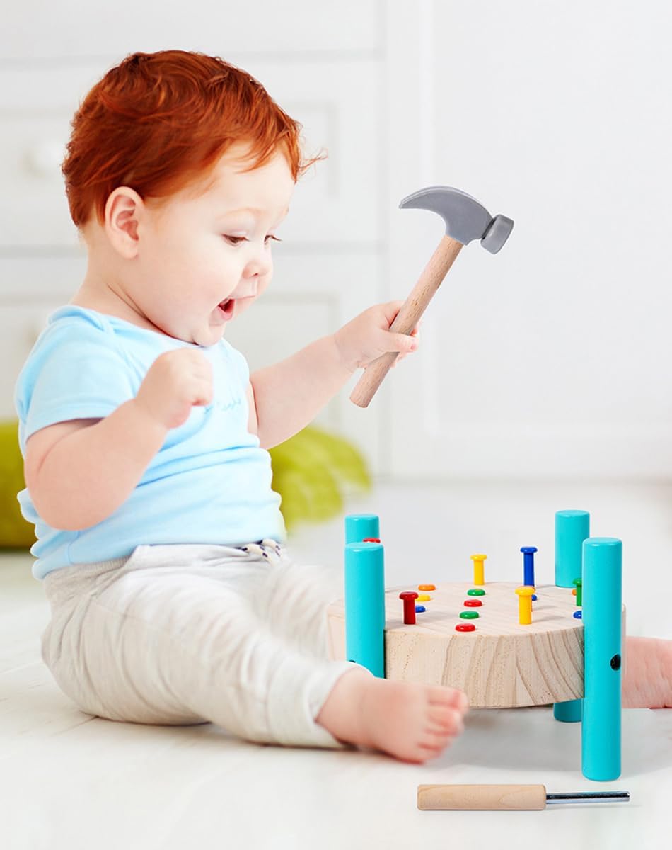 Child playing with a toy hammer and colorful wooden blocks on a light background