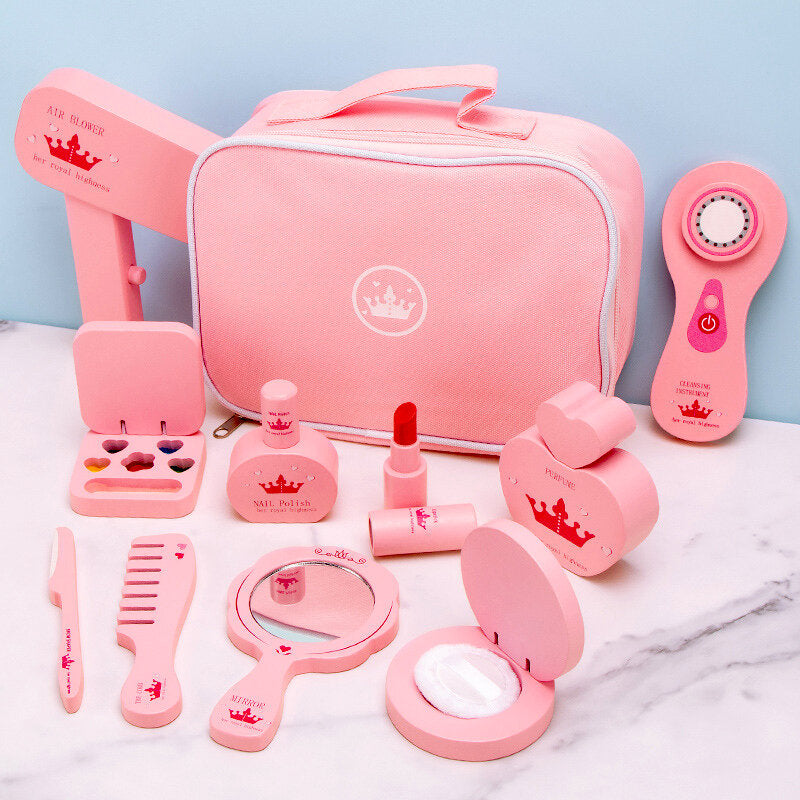 Pink toy makeup set with various items on a marble surface and light blue background